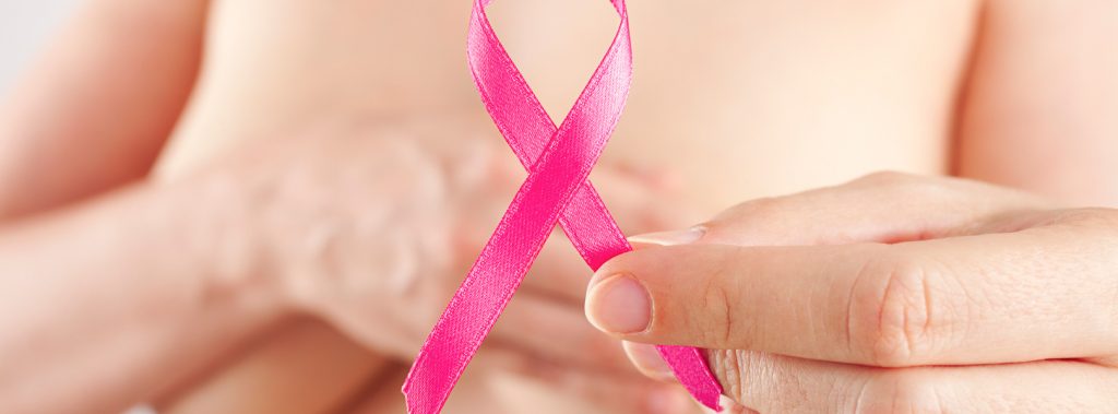 Woman holding pink ribbon