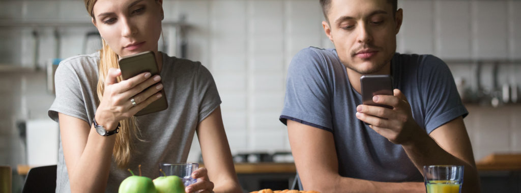 Couple staring at their phones
