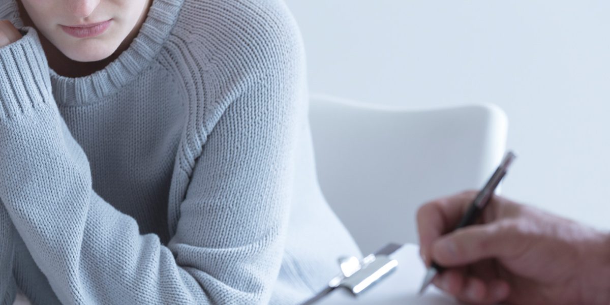 Woman sitting in therapy talking to therapist