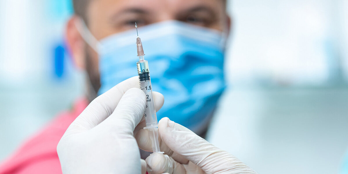 Man preparing to receive a flu shot