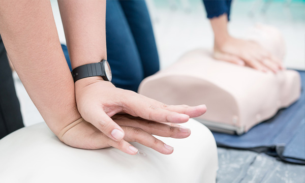 Student practicing chest compressions during a CPR class