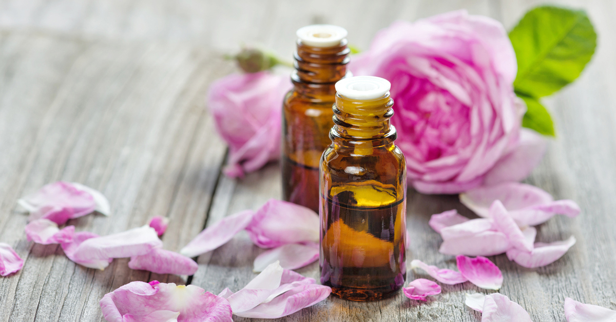 Roses, rose petals and bottles of essential oils