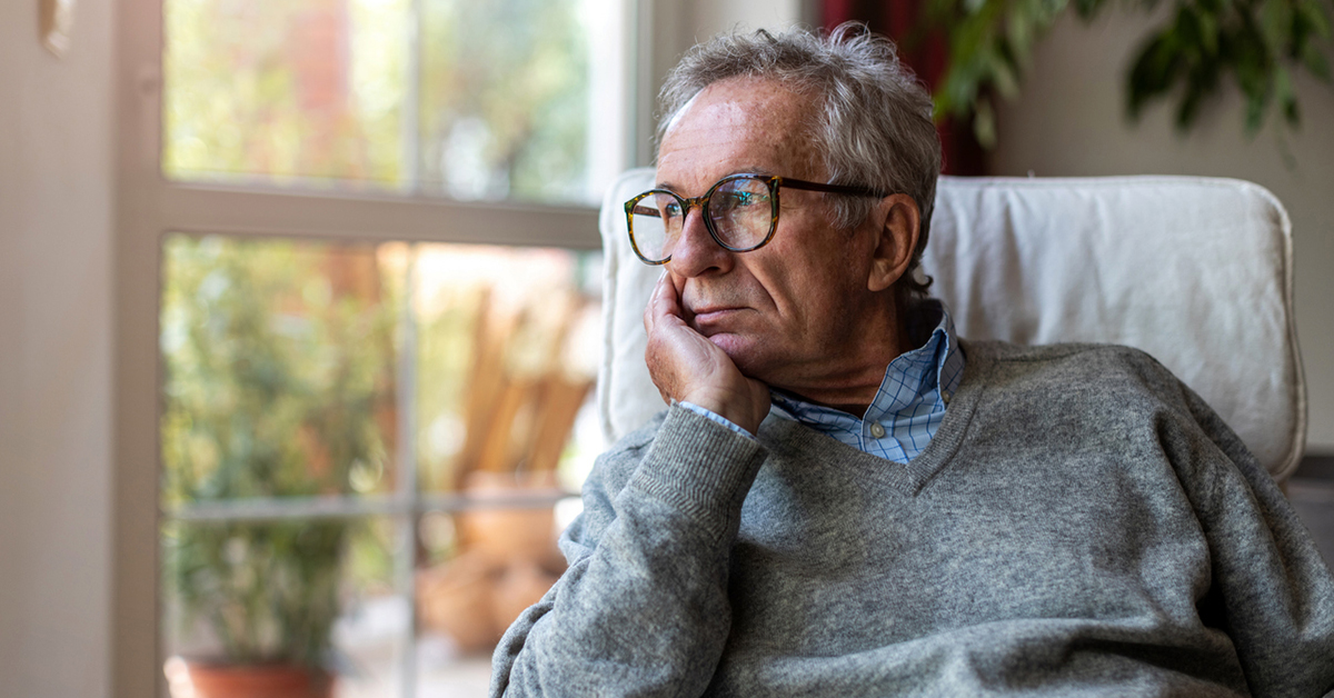 Man looking out of window at home