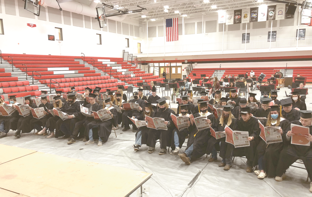 Hinckley-Finlayson High seniors reading the Hinckley News.