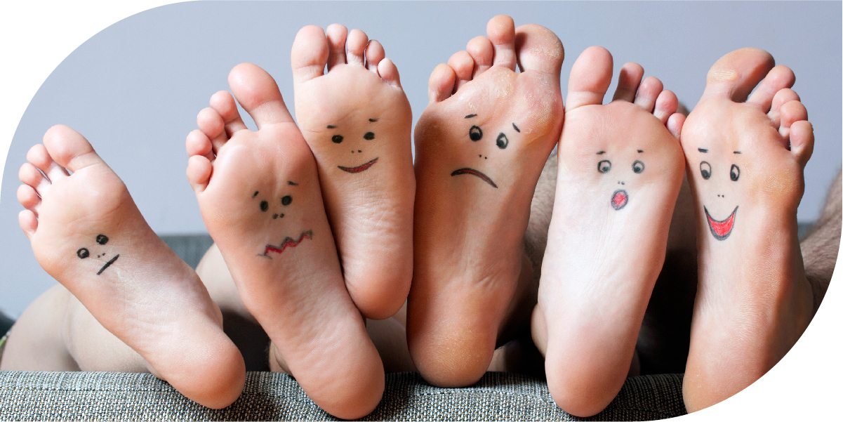 Close up of several feet, all with faces drawn on them