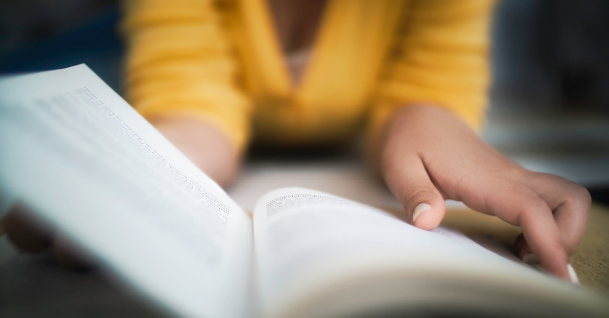Close-up of young female reading a book