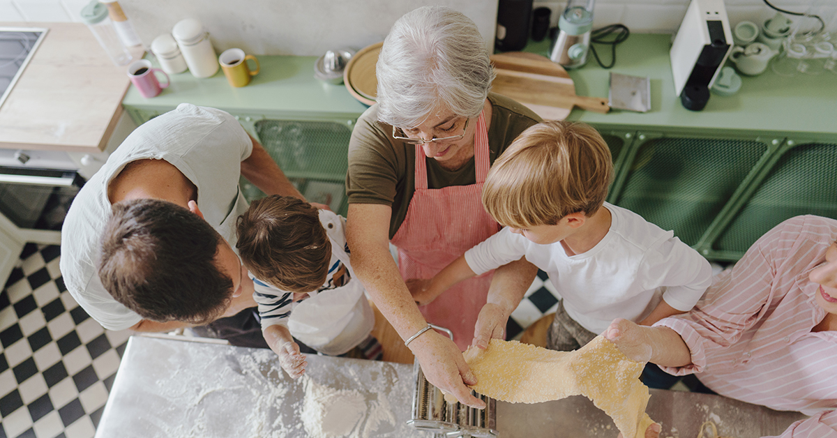 Family gathered in the kitchen baking