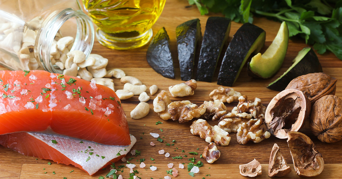 An array of healthy foods, nuts, salmon, avocado