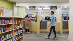 Individual talking to pharmacist about a prescription in the pharmacy