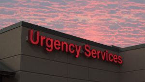 Welia Health-Pine City Urgency Services sign against a beautiful sunset