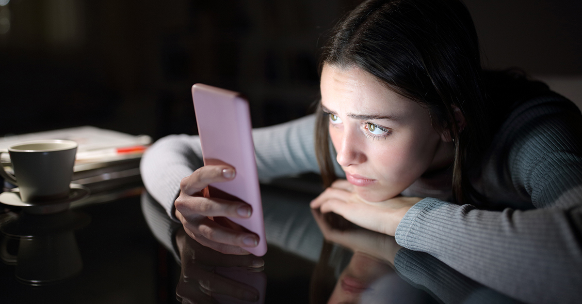 A adolescent girl staring at her phone