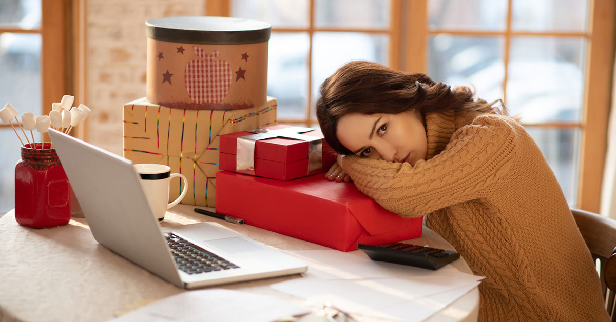 Young woman feeling tired after packing gifts