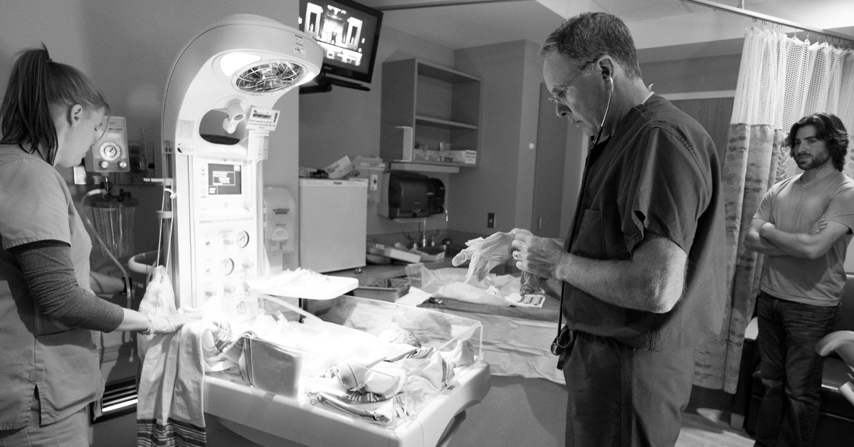 Dr. Peter Donner, caring for one of the many babies he delivered in 35 years at Welia Health