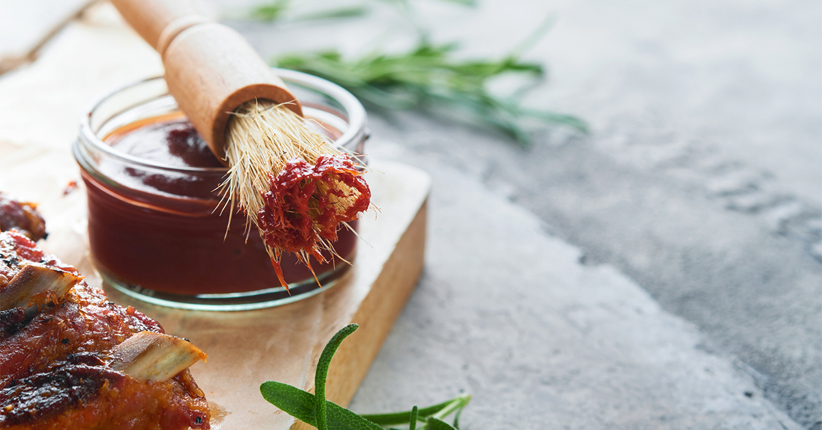 BBQ sauce in jar bowl with basting brush