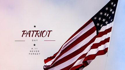 American flag blowing against the sky. Text on the photo says Patriot Day 9/11 never forget.