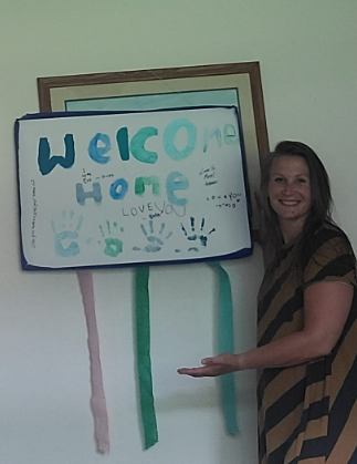 Bethany Sjodin and a welcome home sign after she donated her kidney