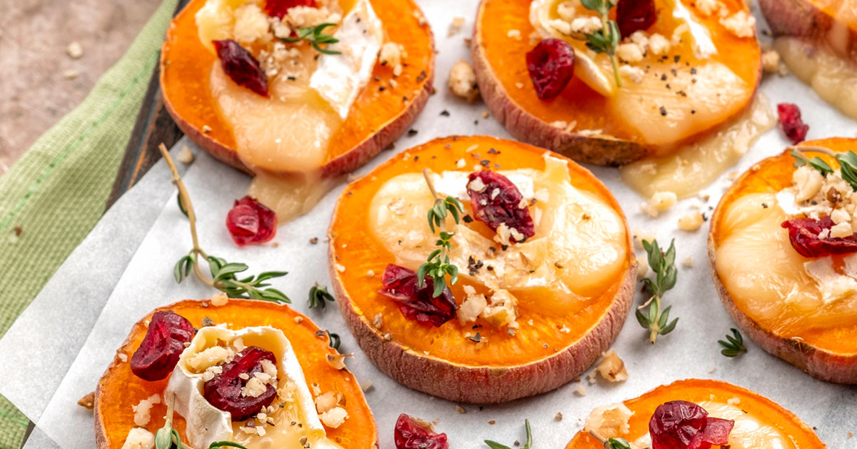 Sweet potato slices topped with cheese cranberries and thyme