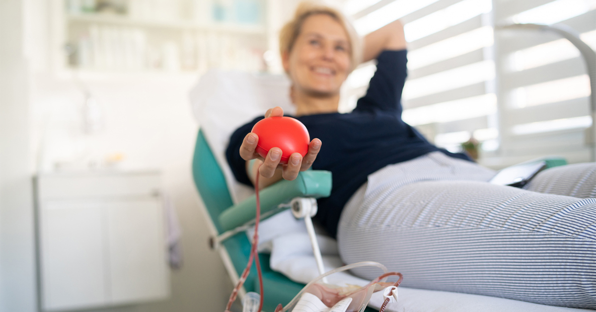 Women reclining in chair donating blood