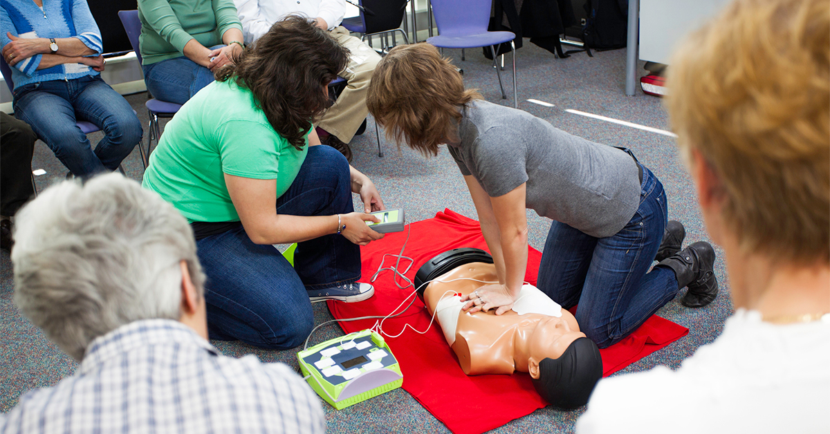 Individual at a CPR class learning chest compressions