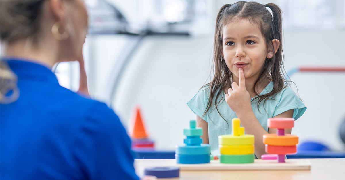 Speech therapist working with a child.