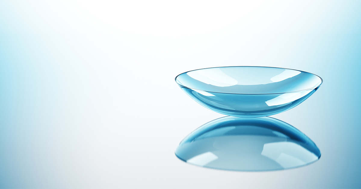 Closeup of contact lens on blue background
