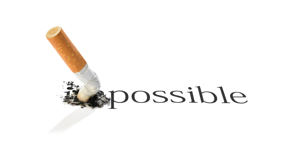 An extinguished cigarette covering the "im" in the word impossible
