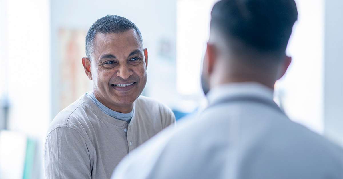 Man and his doctor having a discussion in the exam room