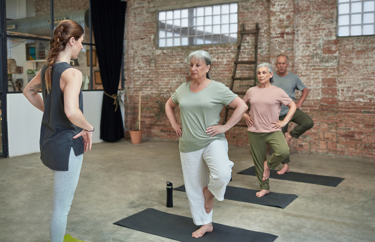 Senior women practicing balance in fitness class