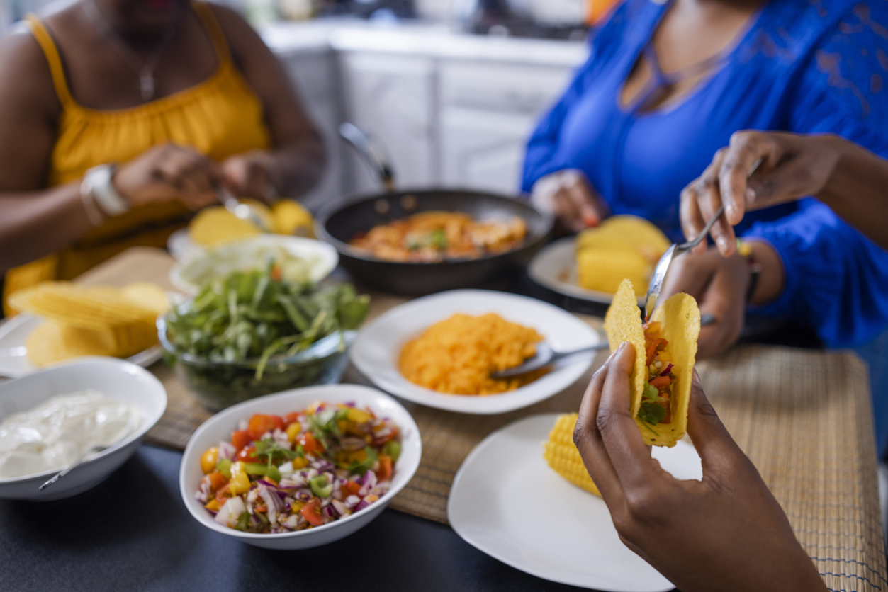 family sitting at a dining table eating tacos