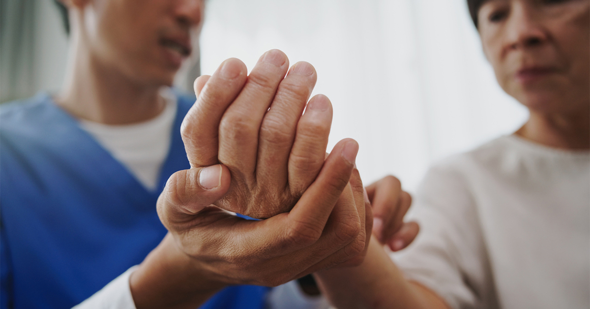 A physical therapist or hand therapist evaluating a patient's wrist